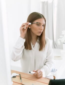 woman applying eyebrow gel
